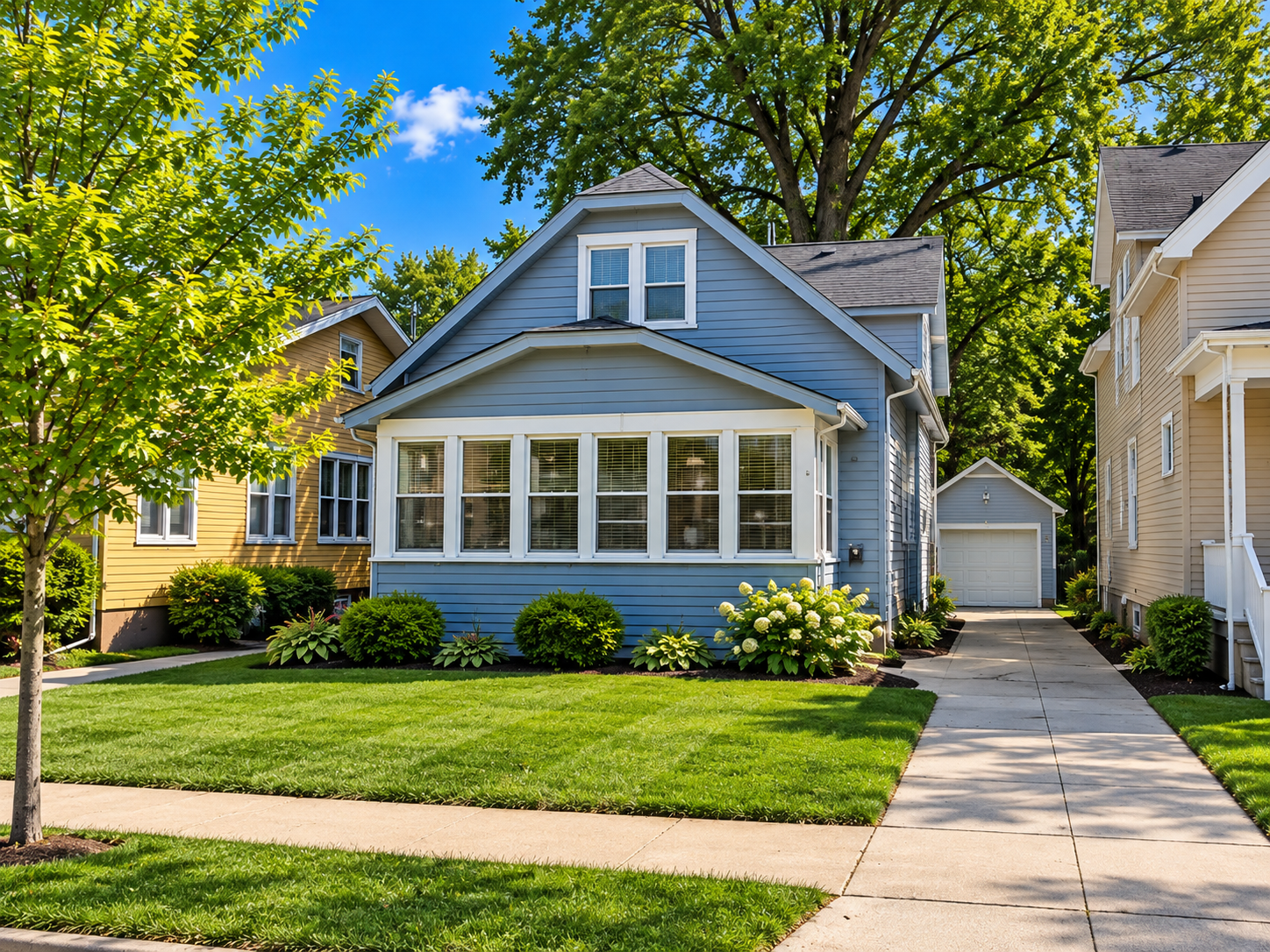 Blue House with Lush Landscaping